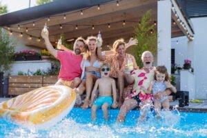 a happy family sitting on a pool